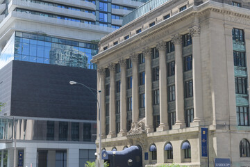 Naklejka premium 88 Harbour condominium complex contrasted with historic Toronto Harbour Commission building, designed by Chapman and McGiffin, in Beaux-Arts style, completed 1917, at 60 Harbour St