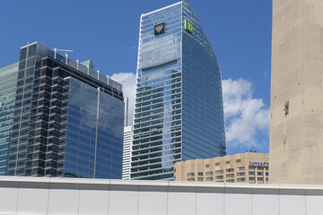 Naklejka premium architectural neighbors: Simcoe Place (200 Front St W), TD Terrace (with Pride Month heart sign, 160 Front St W) and InterContinental hotel - viewed from near Canada Lands Square, Toronto