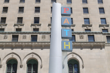 Naklejka premium location marker post with sign of PATH, Toronto’s Downtown Pedestrian Walkway System, and a defocused view of Fairmont Royal York hotel (York St entrance)