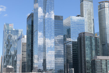 Naklejka premium reflection of a cloudy blue sky on high-rises in the South Core / South Financial District, Toronto