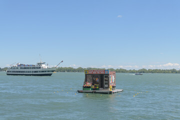 Fototapeta premium art installation known as Global Convenience by Trevor Wheatley and Cosmo Dean floating near Harbour Square Basin, Toronto
