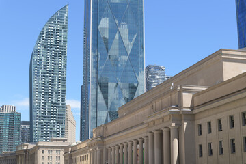 Naklejka premium looking east on Front St W from about York St to L-Tower condo designed by Daniel Libeskind, CIBC Square, and historic Union Station, Toronto