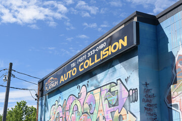 Naklejka premium exterior building facade and sign of Platinum Auto Collision, an auto body shop, located at 2 Cariboo Av, Toronto