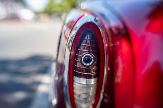 Close-up of a chrome tail light on a vintage red car with selective focus effect, November 2025.
