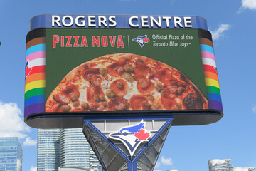 Fototapeta premium Toronto Rogers Centre Gardiner LED Pylon (located at Rees St & Bremner Blvd) with advertisement for Pizza Nova / Toronto Blue Jays