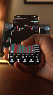 Trader Analyzing Stock Market Charts on Smartphone Through Brokerage App