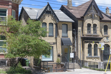 Naklejka premium exterior of Bau-Xi Gallery and PERFECT X HAIR - Art Gallery, historic houses opposite the Art Gallery of Ontario, Dundas St W, Toronto