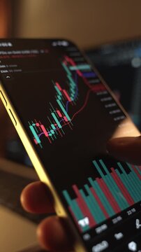 Trader Analyzing Stock Market Charts on Smartphone Through Brokerage App