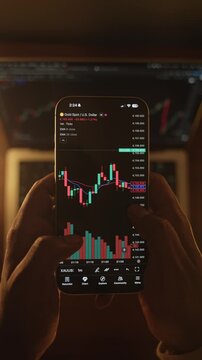 Trader Analyzing Stock Market Charts on Smartphone Through Brokerage App
