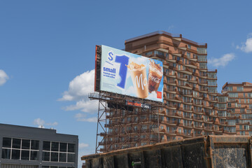 Fototapeta premium spectacular with McDonald's Canada billboard with summer beverages (behind: Aqualuna Condos), Toronto
