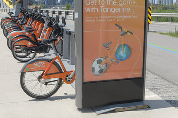 Fototapeta premium Bike Share Toronto docking station with Tangerine Financial slogan poster