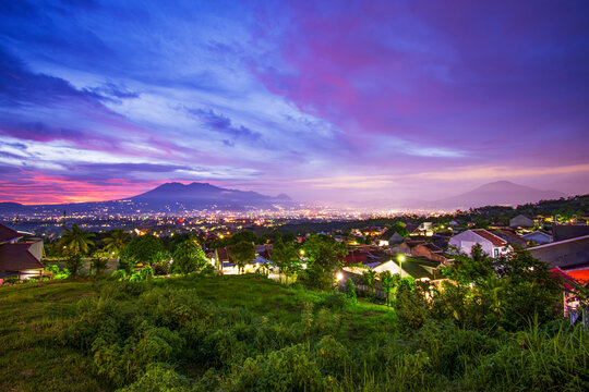 Beautiful twilight over Malang city valley with Mount Kawi and Mount Arjuno views at sunset, East Java, Indonesia