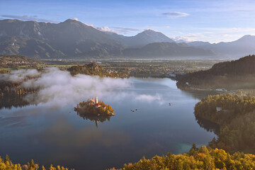 Colorful misty sunrise over the lake (Blejsko Jezero), the Assumption of Mary church and the castle, seen from Mala Osojnica hill. Bled-Slovenia-083