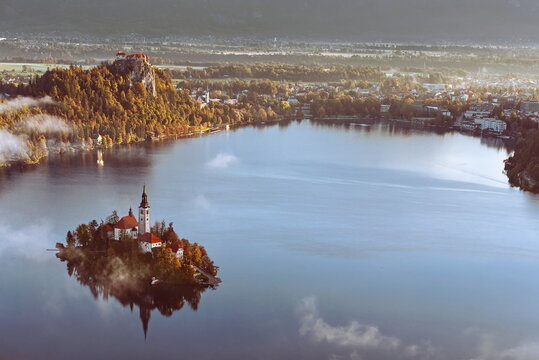 Colorful misty sunrise over the lake (Blejsko Jezero), the Assumption of Mary church and the castle, seen from Mala Osojnica hill. Bled-Slovenia-078