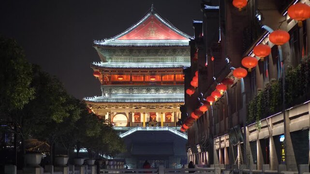 Illuminated traditional Chinese tower with red lanterns at night in Xi'an in Xi an, China
