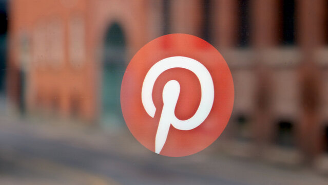 Manchester, England, UK - 18 June 2026: Pinterest logo close up, social media brand icon on glass window, digital marketing sign, corporate identity, blurred city background