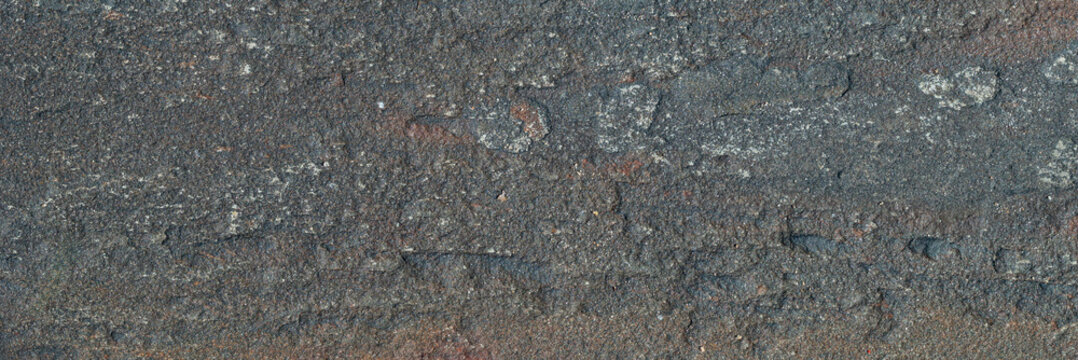 Stone texture. Minimalist dark grey basalt rock surface texture with fine grain structure.