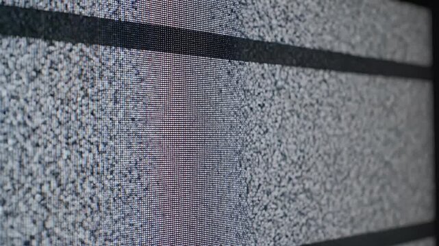 Close-up of television static on a screen.