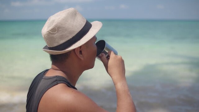 Relaxed Man Drinking Coffee by the Beach on a Bright Day, Representing Coastal Leisure, Mindfulness, Wellness, and a Calm Holiday Lifestyle