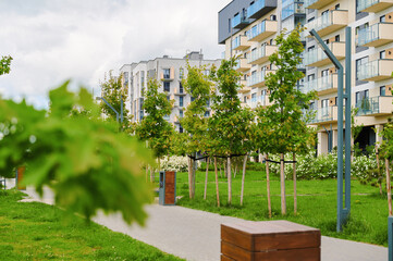 Fototapeta premium Modern residential complex with green spaces. Contemporary architecture and landscaping create a harmonious living environment.