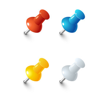 Set of four colorful plastic push pins in red, blue, yellow, and silver colors with metallic sharp points isolated on a transparent background
