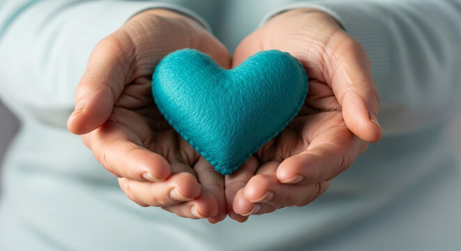 Hands Holding Teal Felt Heart Support Charity Healthcare Concept