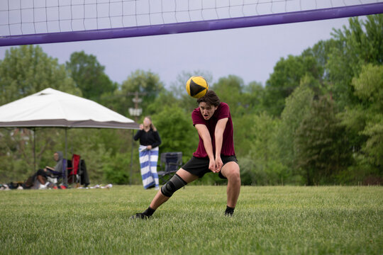 Male volleyball player passing a hard serve