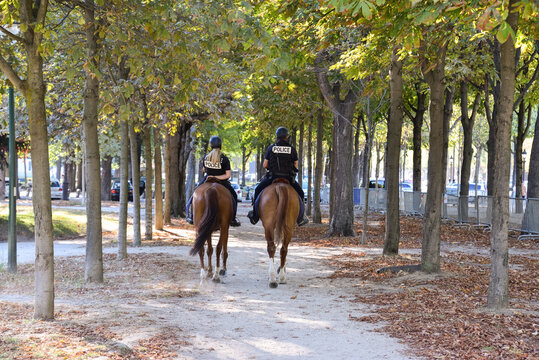 Policeman and Policewoman on Horses at Champs Elysees in Paris, France