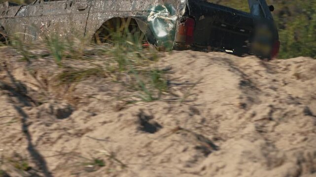 Powerful off-road truck competing in rally. Low angle view shows muddy tires spinning fast, kicking up sand and dirt. Sense of speed, power, and adventure in extreme sport
