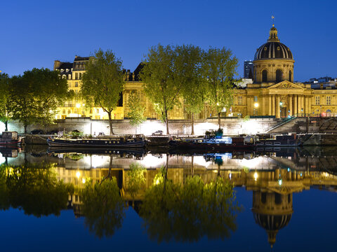 Seine River with Ships and Reflection of Historical Buildings in Paris, France