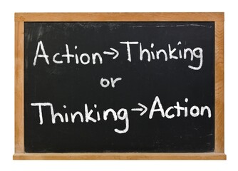Fototapeta premium Action then Thinking or Thinking then Action written in white chalk on a black chalkboard isolated on white