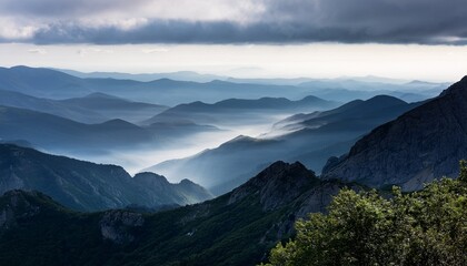 Fototapeta premium Misty Mountains With Fading Layers Under Cloudy Sky