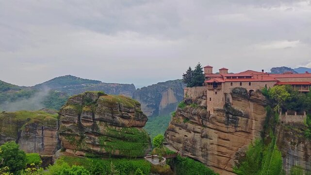 Aerial view of Meteora monasteries and the rock formations in the mountains of Greece near Kalabaka city. Monastery of the Holy Trinity. Unesco world heritage site. Drone Video