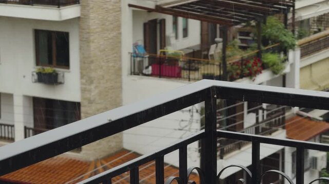 Rain Drops Falling On Metal Balcony Railing. Rainy Weather. Overcast Sky Day