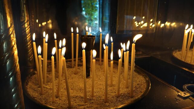 Burning Thin Wax Candles In Sand Candlestick. Orthodox Christian Church. Religion And Faith. Prayer Ritual