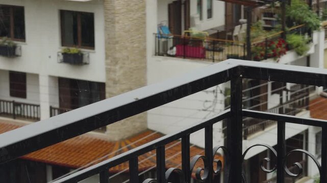 Balcony Railing  Of Apartment Building Under Rain. Residential House on Rainy Day