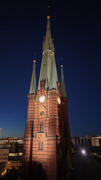 Aerial view of Saint Clara Church (Klara kyrka) in Norrmalm, downtown Stockholm, Sweden. Cinematic drone shot of the iconic Gothic Revival brick tower and cityscape.