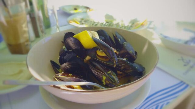 Steamed Mussels In Shells With Sauce And Lemon Slice.  Mediterranean Seafood Dish. Gourmet Appetizer