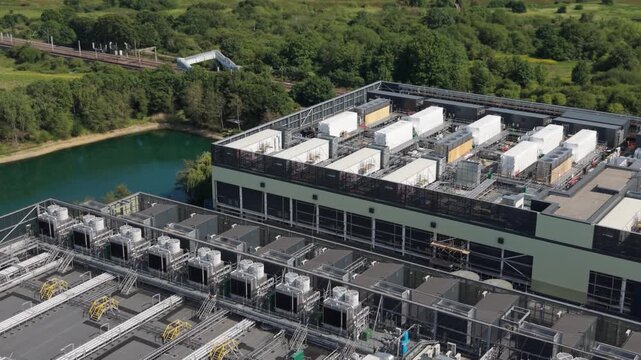 Expansive Data Center Facility by a Lake and Railway Track in Daylight