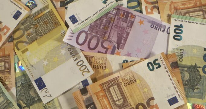 Close-up view of various Euro banknotes on a surface