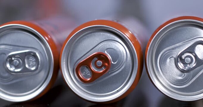 Close-up view of opened beverage cans with focus on pull tabs