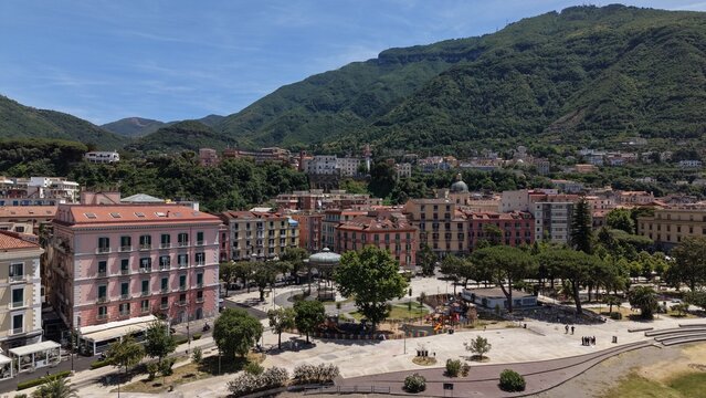 Aerial view of Castellammare di Stabia Villa Comunale square with Cassa Armonica gazebo, colorful buildings and Monte Faito mountain, Naples, Italy
