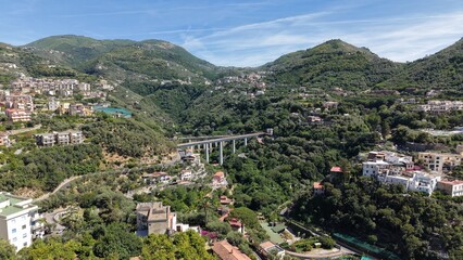 Fototapeta premium Aerial view of historic Ponte di Seiano Bourbon bridge and modern Viadotto del Rivo d'Arco over green valley in Vico Equense, Naples, Italy 