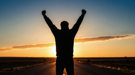 Fototapeta premium Silhouette of a person with arms raised in victory on an open road at sunset. Achieving goals and personal triumph as the sun sets in the background, embodying hope and aspiration.