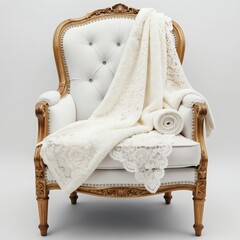 Naklejka premium Ornate gold armchair draped with plush white blanket. Features elegant lace trim, button tufting. Cozy, sophisticated seating for home decor.