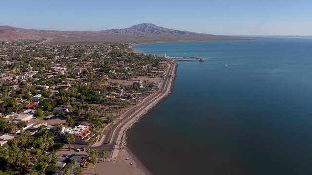 Watch aerial views of Loreto waterfront and malecon during sunrise in Baja California Sur, Mexico.