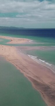Amazing tropical beach anc blue transparent sea ocean water. Aerial view of coastline and amazing seascape landscape with horizon and sky and mountains in background. Summer travel