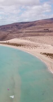 Amazing tropical beach anc blue transparent sea ocean water. Aerial view of coastline and amazing seascape landscape with horizon and sky and mountains in background. Summer travel