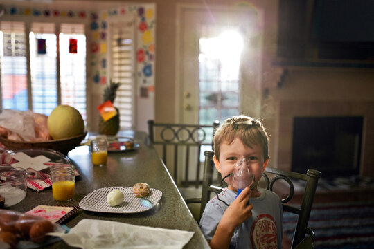 Little boy using aerosol mask for asthma