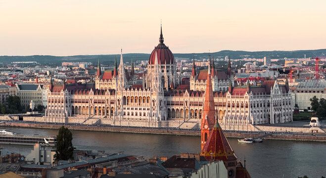 Golden-hour panoramic view of the Hungarian Parliament Building overlooking the Danube River.